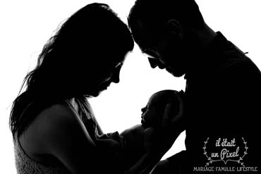 Photo noir et blanc d'un bébé et ses parents lors d'un shooting en studio